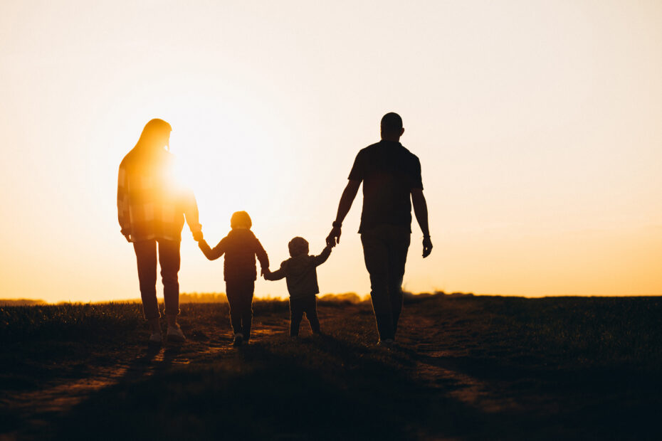 Silhouetted family of four walks hand-in-hand at sunset, walking into the future. Text: “The Evolution of Homeschooling and Where We Think It’s Headed.”