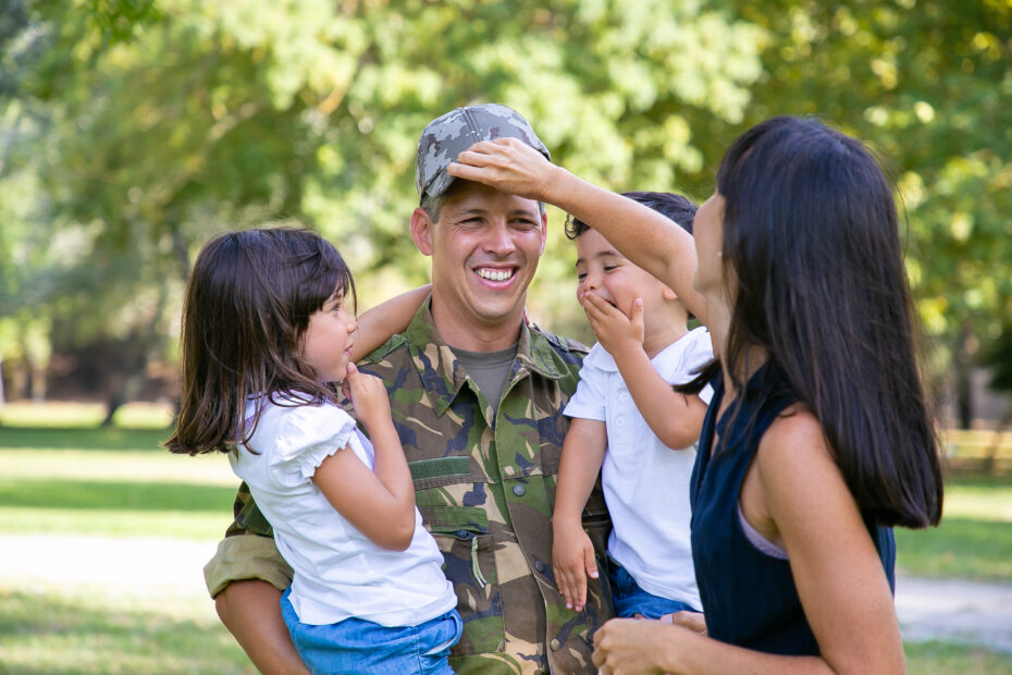 A man in military camo lifts a smiling child outdoors, surrounded by trees. Text below reads “What the Federal COMPASS Act Could Mean for Homeschooling Nationwide.”