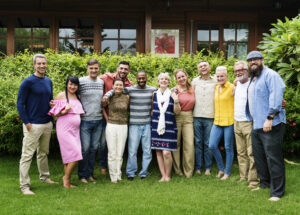 a group of diverse homeschooling parents smile and pose outdoors