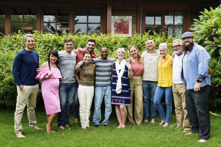 a group of diverse homeschooling parents smile and pose outdoors